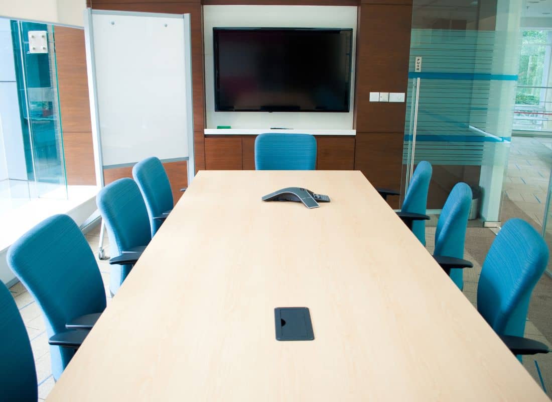 Image of a spacious and well-lit training room in Singapore, equipped with comfortable chairs, a projector, and a whiteboard, ideal for private tutors seeking the perfect space to conduct their training sessions
